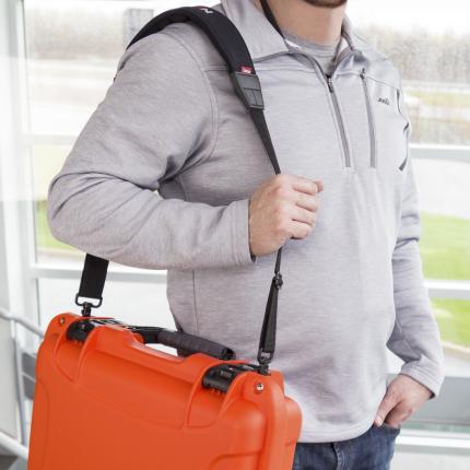 Nanuk Shoulder Strap attached to case being carried by a man.