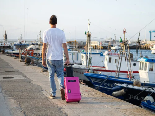 Peli 1510 in Pink being used a a trolley suitcase.